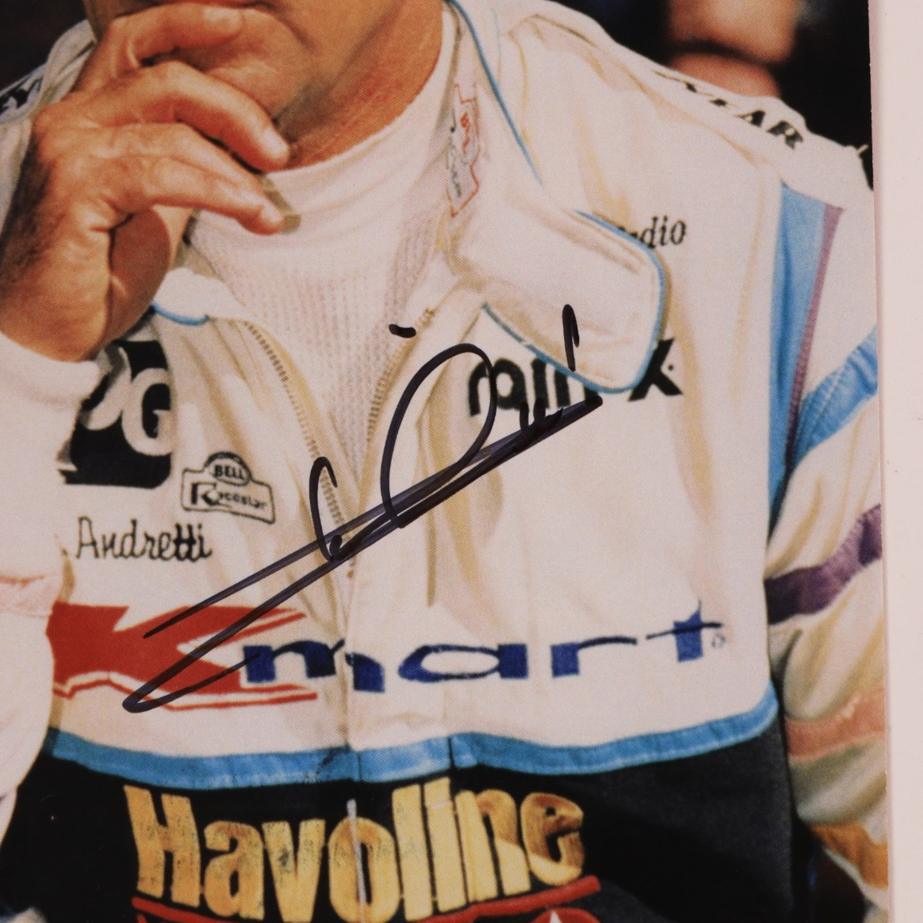 Signed Formula 1 memorabilia, including 1973 Milestones magazine signed to the front cover by Graham Hill and three signed photographs comprising Jackie Stewart, Jack Bradbury and Mario Andretti, with certificate of authenticity from Chaucer Auctions