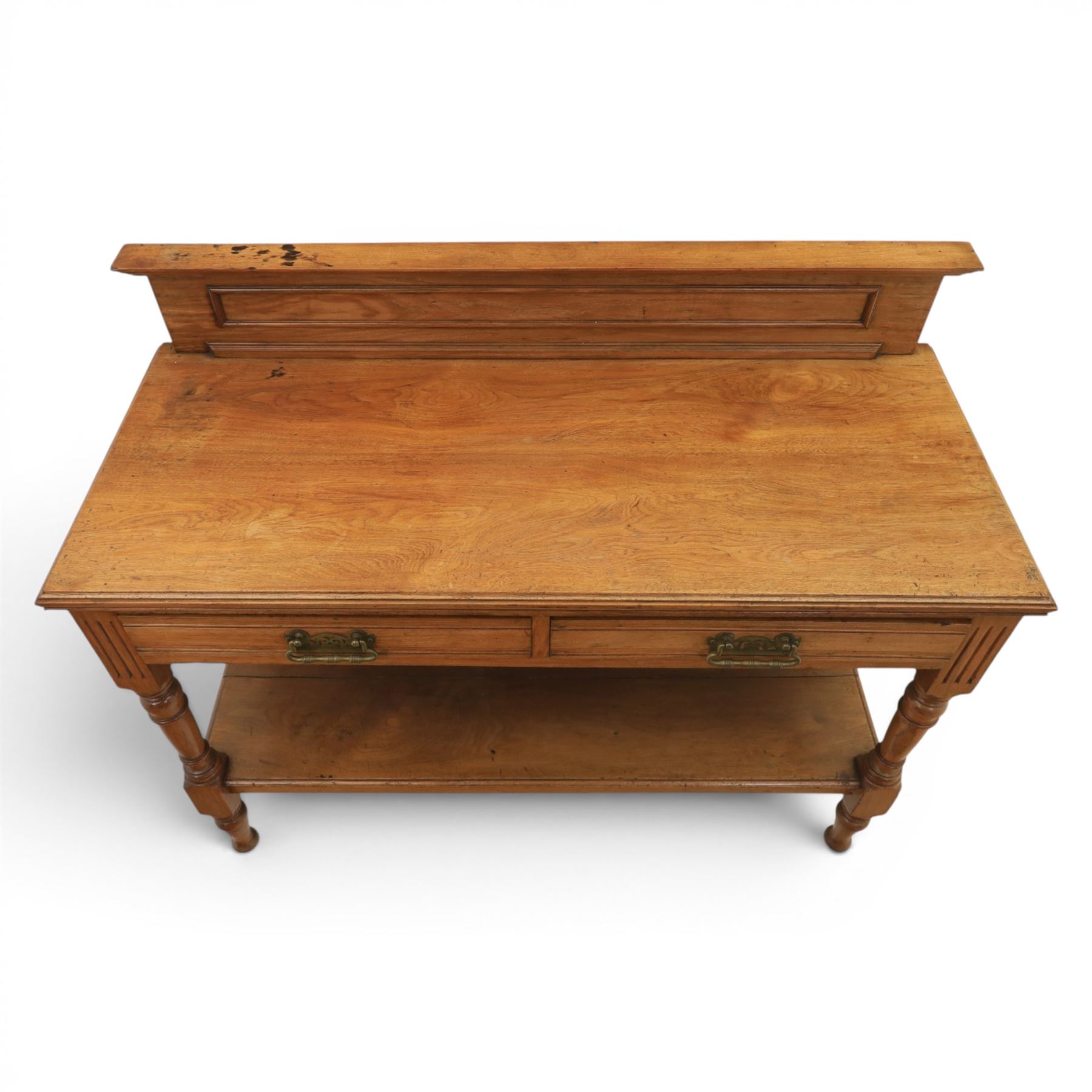 Edwardian oak serving table, raised panelled back over moulded rectangular top, fitted with two frieze drawers with brass drop handles, fluted front uprights, on turned supports united by potboard undertier