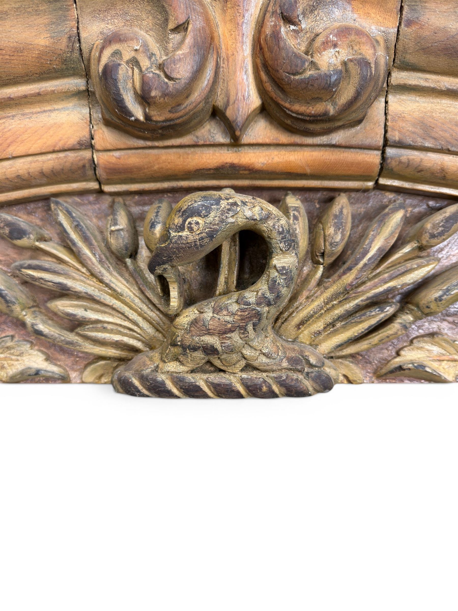 19th century carved pine architectural pediment, detailing floral swags with berries and central serpentine snake head 