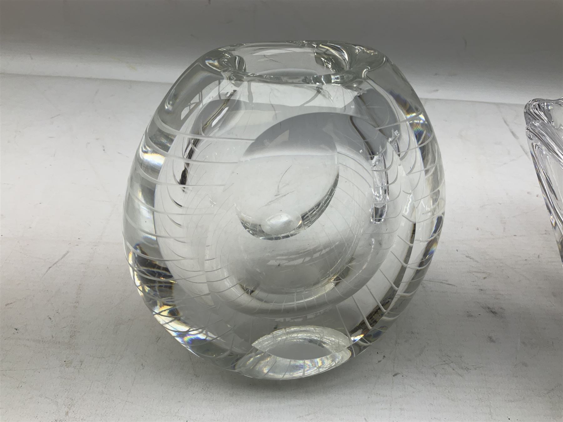 Two Orrefors Art Glass clear glass vases, the first example of compressed circular form, the second of tapering form with lobed rim, each signed beneath, tallest H14.5cm