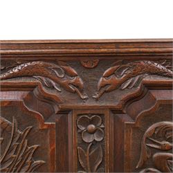19th century Gothic Revival heavily carved oak settle or hall bench, the high quadruple back with moulded cresting rail over a frieze carved with stylised dolphin and sea creature motifs, the panels decorated with griffin and bird motifs with floral dividing rails, the shaped apron similarly carved with scaly sea beasts, on three cabriole front-supports united by stretchers