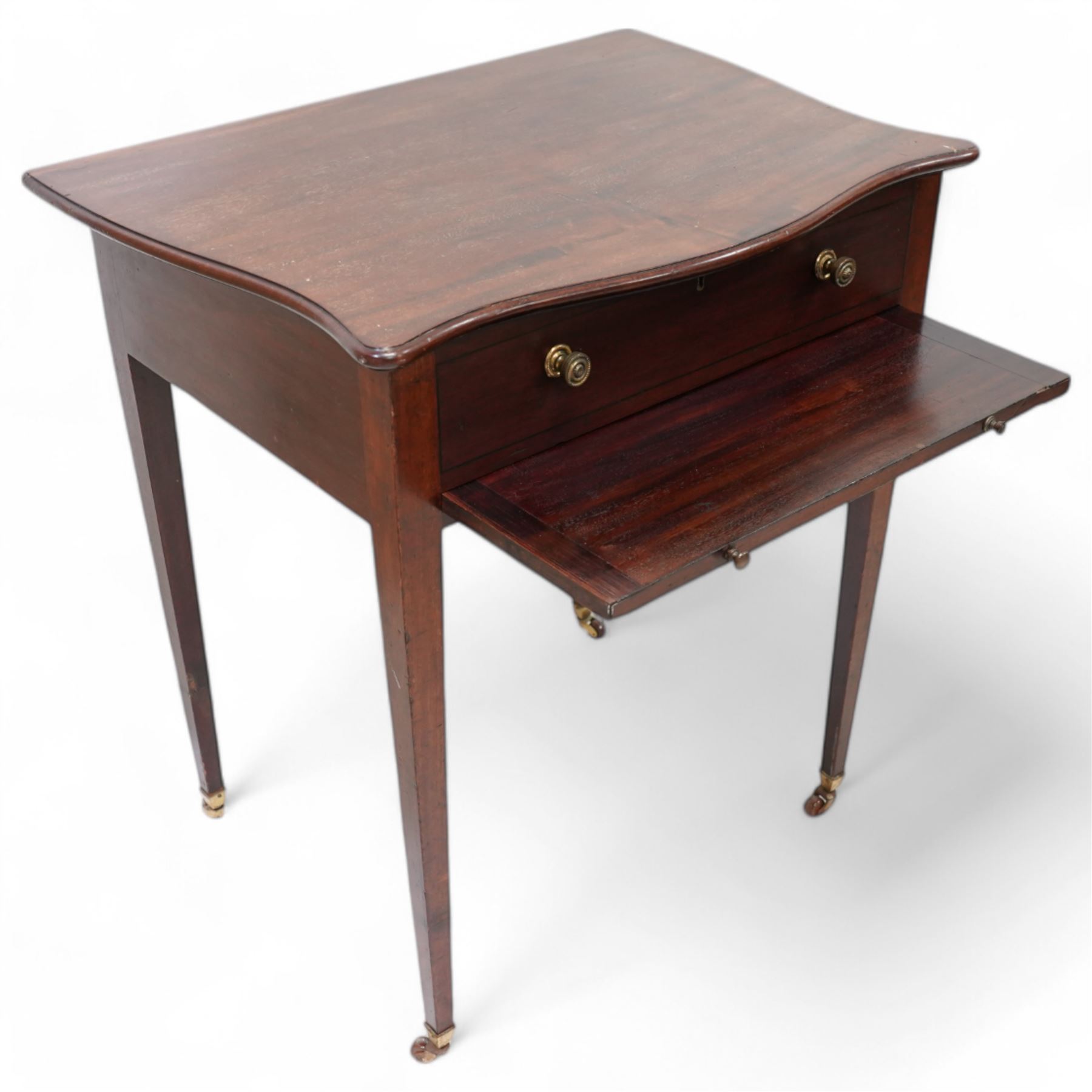 Edwardian mahogany sewing or work table, of shaped form, moulded hinged lid enclosing lidded compartments, fitted with slide, on square tapering supports with brass and ceramic castors 