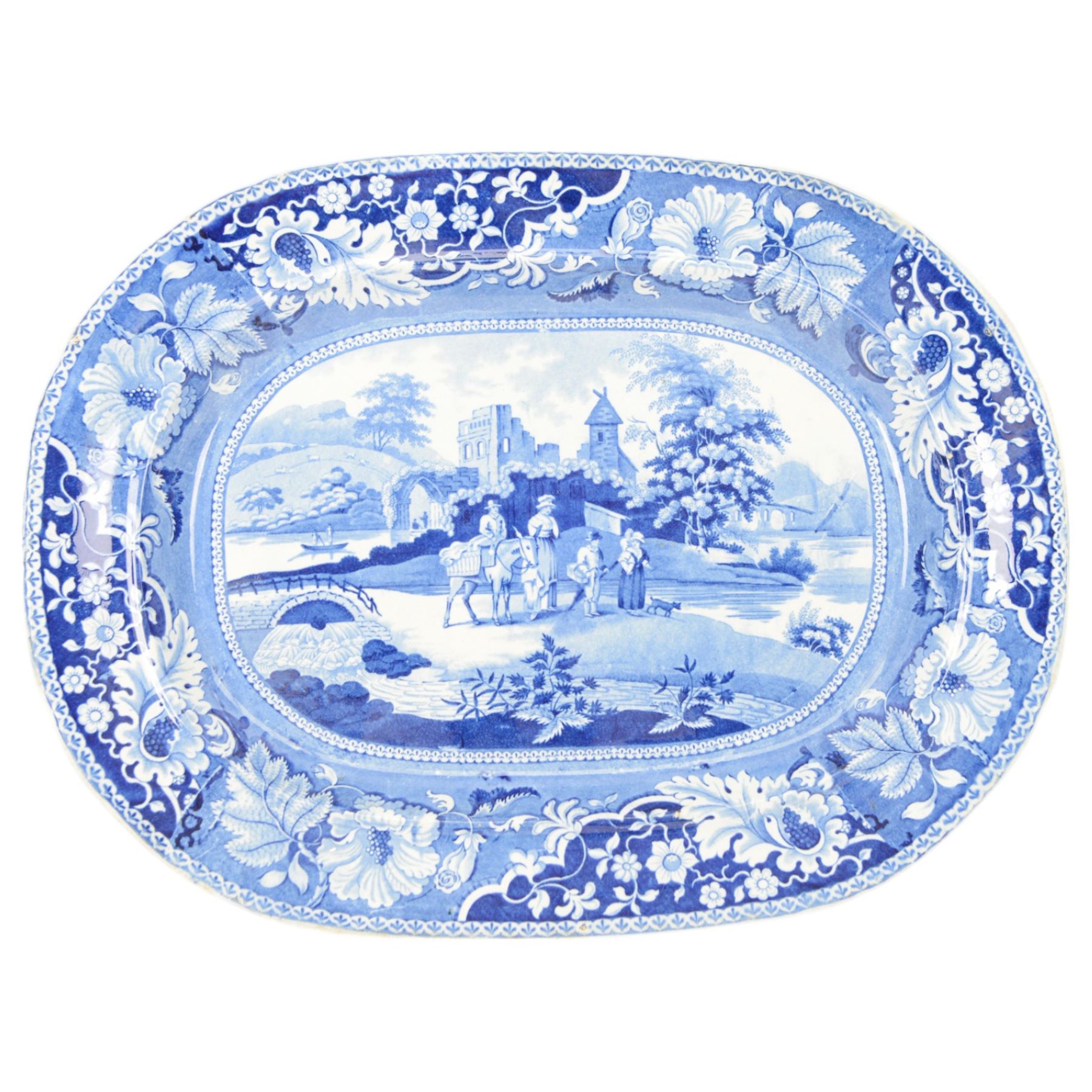 Early 19th century Henshall & Co blue and white transfer printed platter, depicting figures by a lake with floral border, W53cm