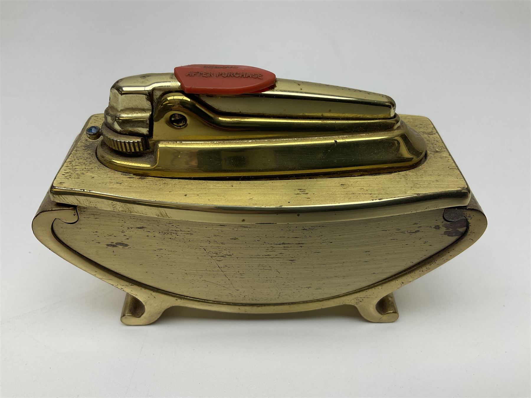 Ronson gilt metal table lighter, together with a silver-plate table lighter in the form of a football boot