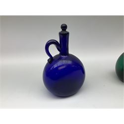 Two 19th century green and blue glass decanters, each of bottle form with handle to the neck and shoulder, and stopper, H20cm