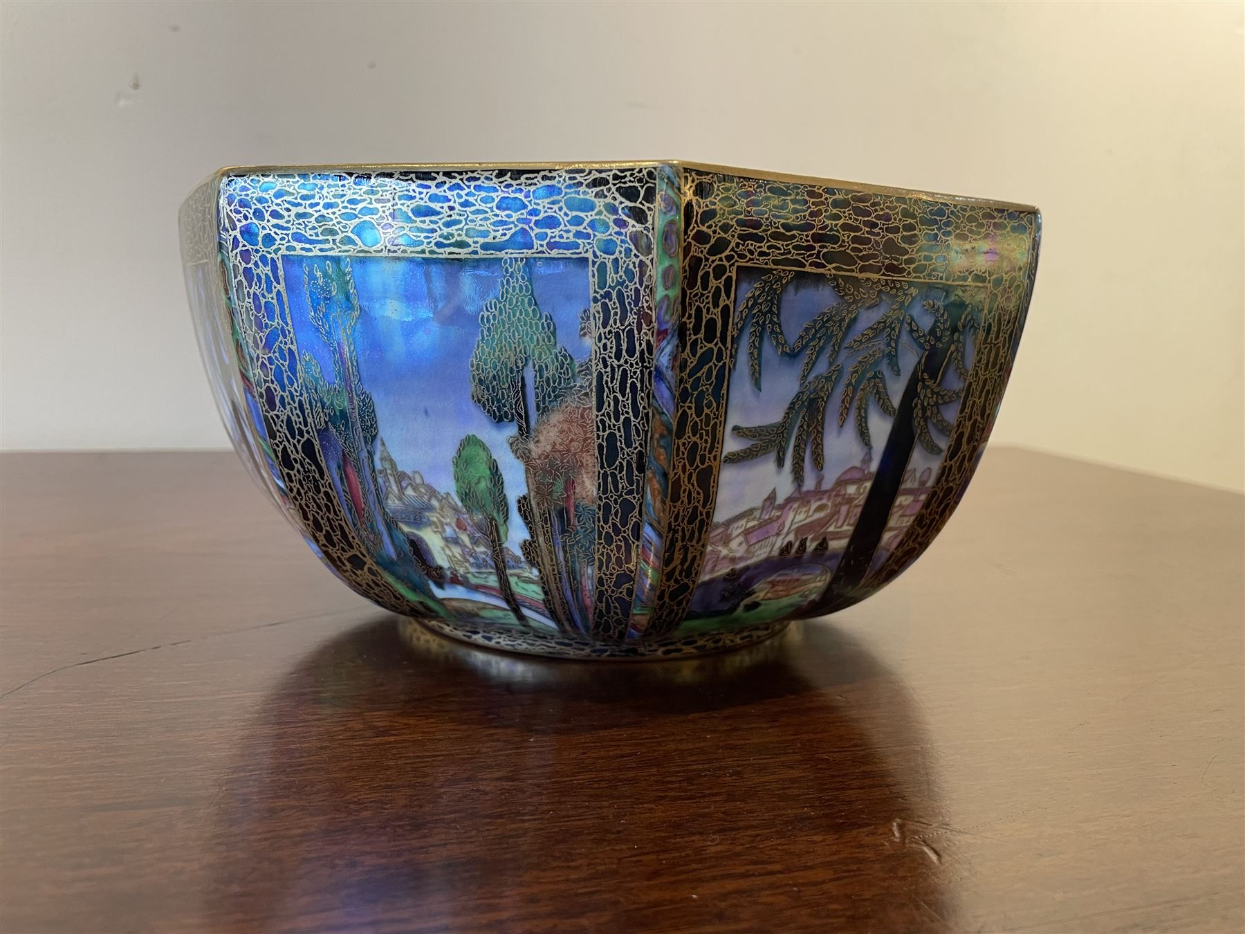 Early 20th century Wedgwood Fairland lustre bowl, circa 1920, of octagonal form, designed by Daisy Makeig-Jones, the exterior decorated in the Castle on the Road pattern, the interior decorated in the Fairy in a Cage pattern, pattern no Z5125, with printed marks beneath, H11cm D22.5cm
