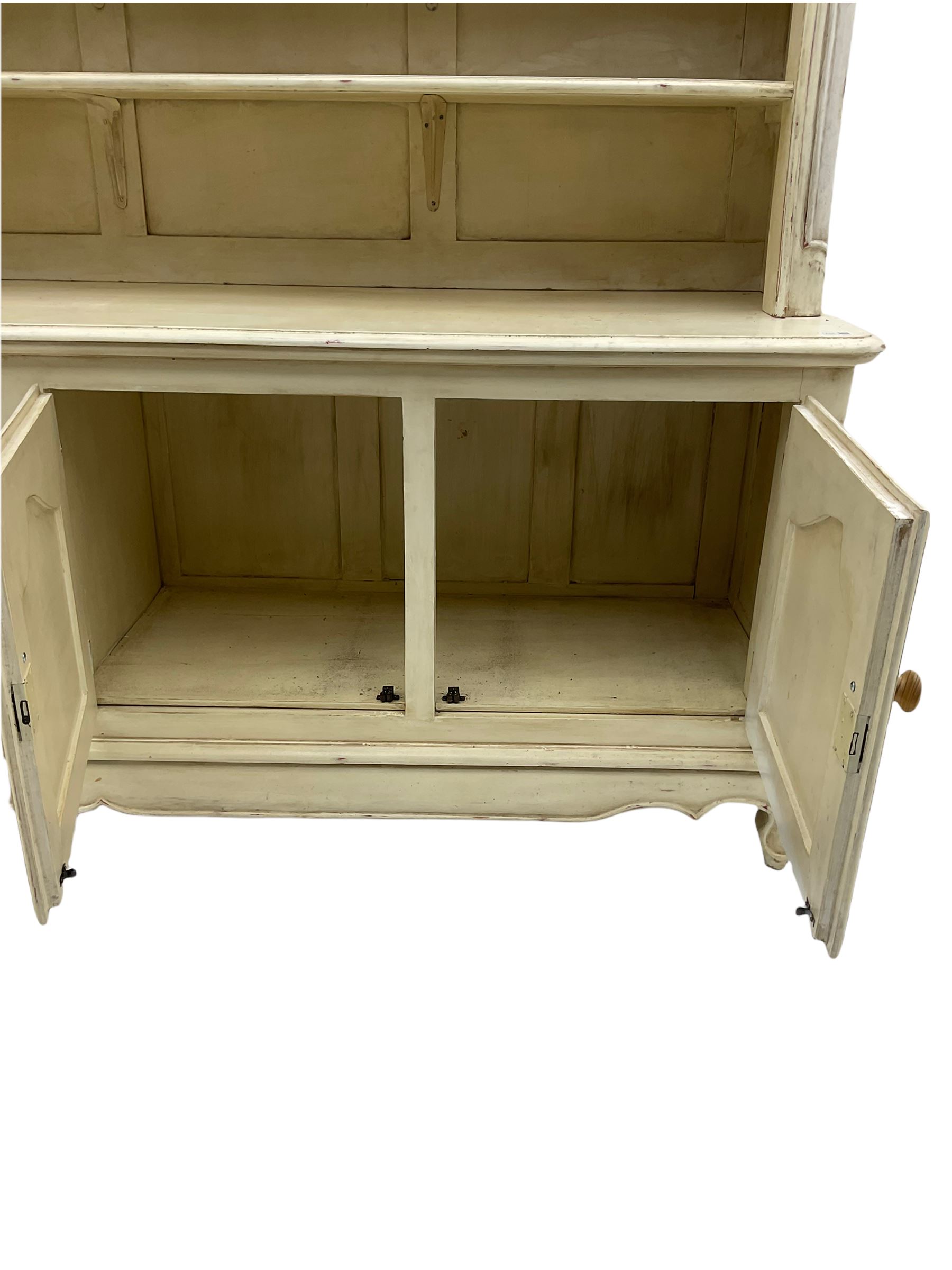 Large French style cream painted dresser, fitted with four cupboards and three tier plate rack