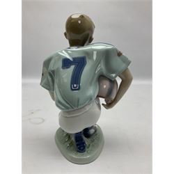 Lladro figure, Football Player, modelled as a young boy playing American football in kneeling position, sculpted by Joan Coderch, with original box, no 6107, year issued 1994, year retired 1998, H18cm