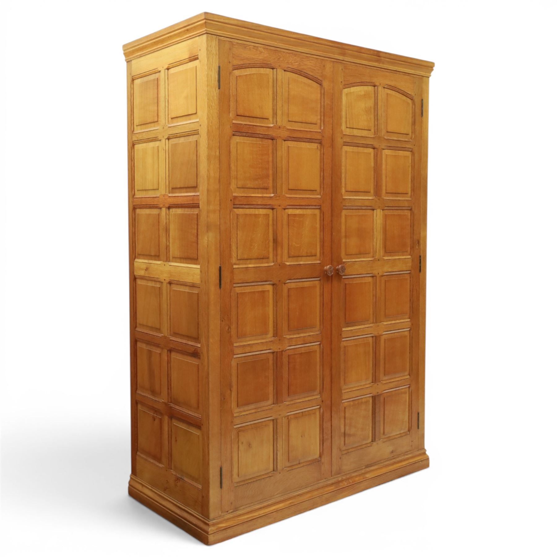 Beaverman - oak double wardrobe, enclosed by twin multi-panelled doors, Yorkshire Rose carved handles, the interior fitted with shelf and hanging rail, with signature carved beaver, by Colin Almack of Sutton, near Thirsk