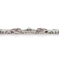 Art Deco platinum diamond and ruby bracelet, circa 1920-1930, the central panel set with a single emerald cut diamond of approx 0.55 carat, flanked by two baguette cut diamonds and old cut diamond surround, the articulated geometric design bracelet with vari-cut rubies, round and baguette cut diamonds, total diamond weight approx 7.00 carat, in Mappin & Webb silk and velvet lined box