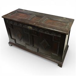 18th century oak coffer, the three panel hinged lid above a frieze carved with repeated lu...