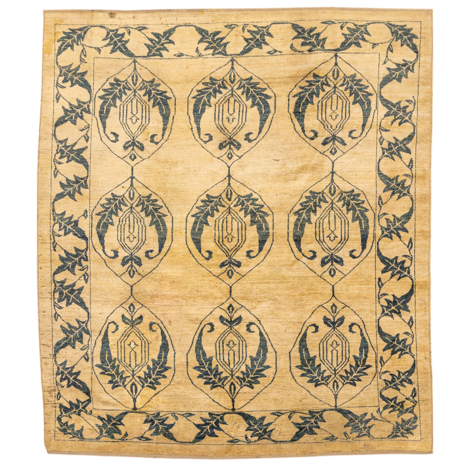 Late 20th century Turkish hand-woven carpet, golden beige field decorated with a repeating lattice of stylized medallions enclosing boteh and angular foliate motifs linked by issuing scrolling vinery within a border of complementary stylized leaf scrolls
