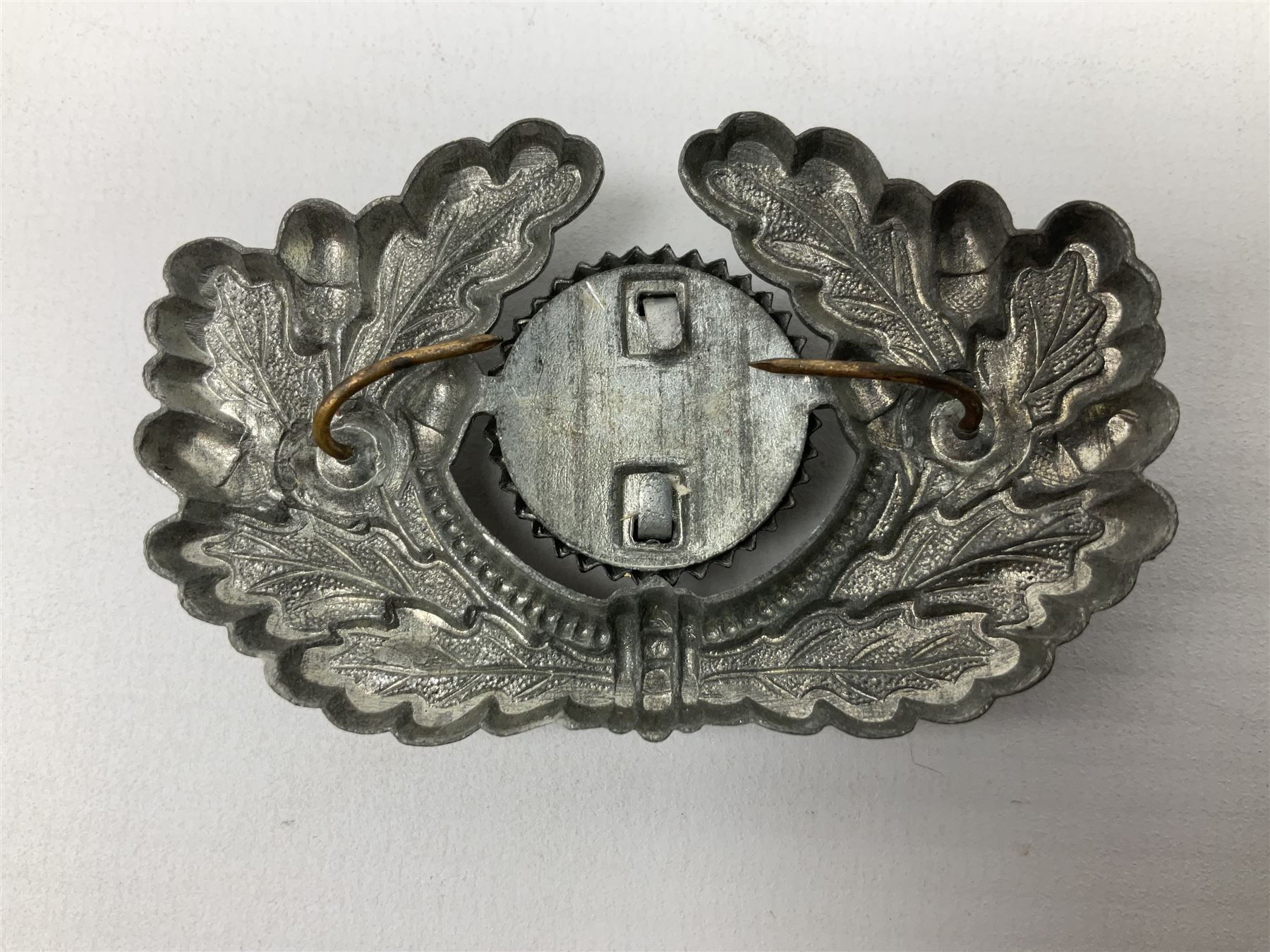 Five WW2 German peaked cap badges, four with double-pinned backs