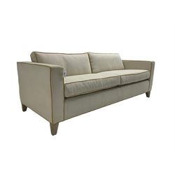 Neptune - pair three seat 'Shoreditch' sofas,  upholstered in cream fabric with yellow stringing