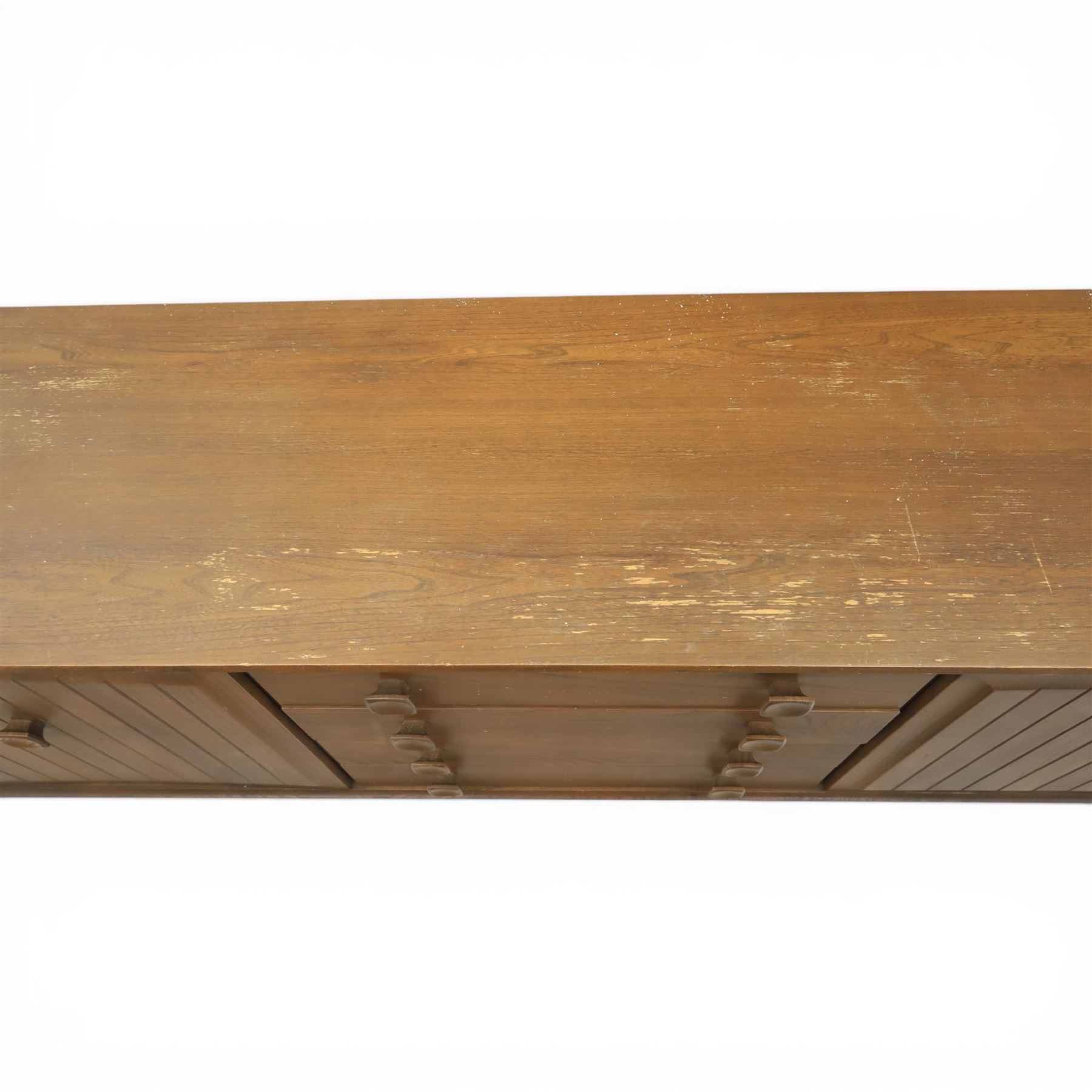 Ensign - Mid-20th century elm sideboard, with a central bank of four drawers, flanked by cupboard doors, raised on tapering supports, labelled Ensign Bristow & Townsend Ltd