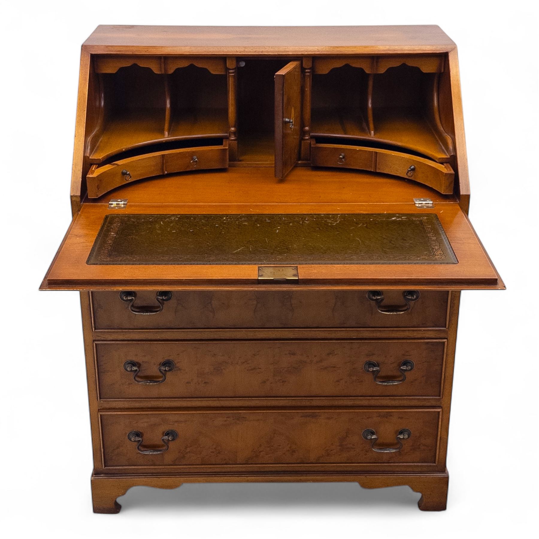 Mid-20th-century Georgian design cherrywood and burr walnut  veneered bureau, fall front with inset tooled leather writing surface revealing a fitted interior with small drawers and pigeon holes, and a central cupboard with oval inlay, over four long graduated drawers, raised on shaped bracket feet 
