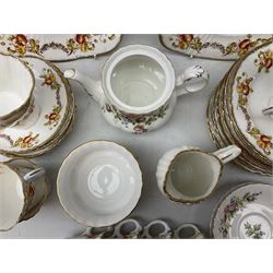 Quantity of Royal Albert tea wares to include 'Moss Rose' teapot, sucrier and saucers, together with teacups, saucers, side plates, jug etc decorated with orange, yellow and blue floral sprays with gilding upon plain ground, all stamped Royal Albert beneath