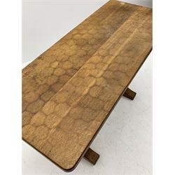 'Acornman' oak table with rectangular adzed top, shaped end supports on sledge feet joined by pegged stretcher carved with acorn signature, by Alan Grainger of Brandsby, York