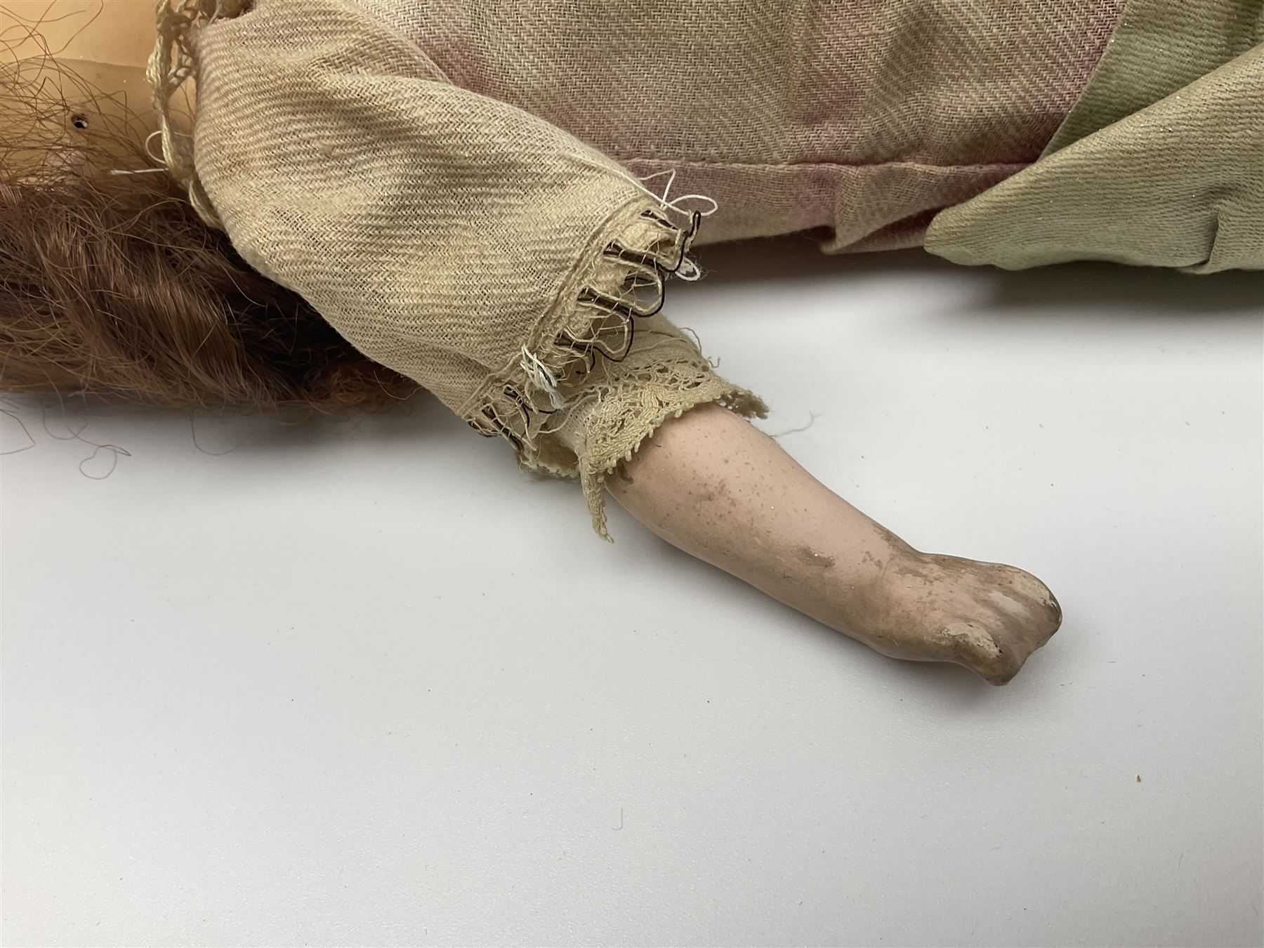 Victorian wax shoulder head doll with applied hair, inset glass eyes and jointed body with composition lower limbs; faded pink dress H35cm