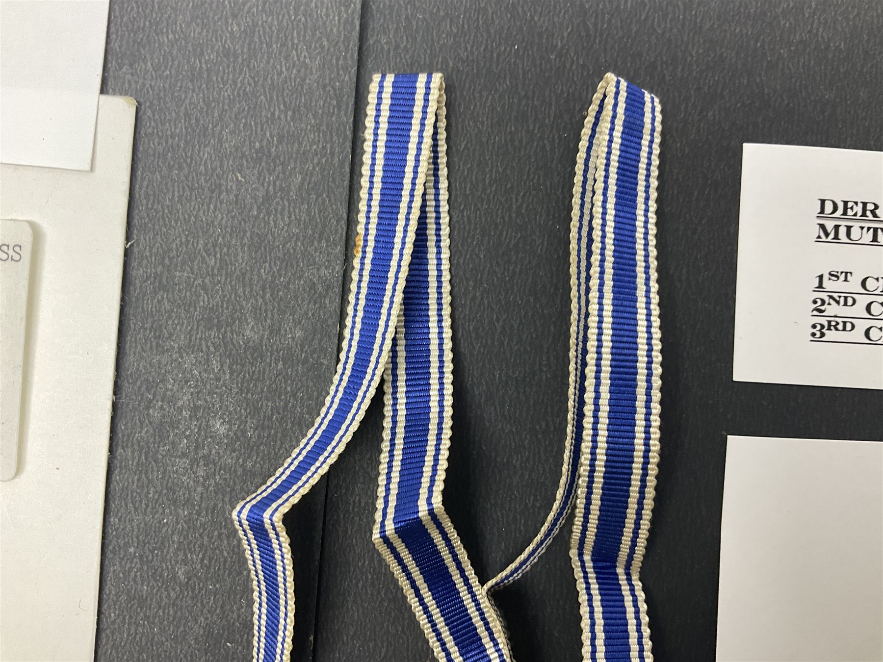 WWII set of three German Mother's Crosses, 1st Class in gilt, 2nd Class in silver and 3rd Class in bronze; all with ribbons (3)