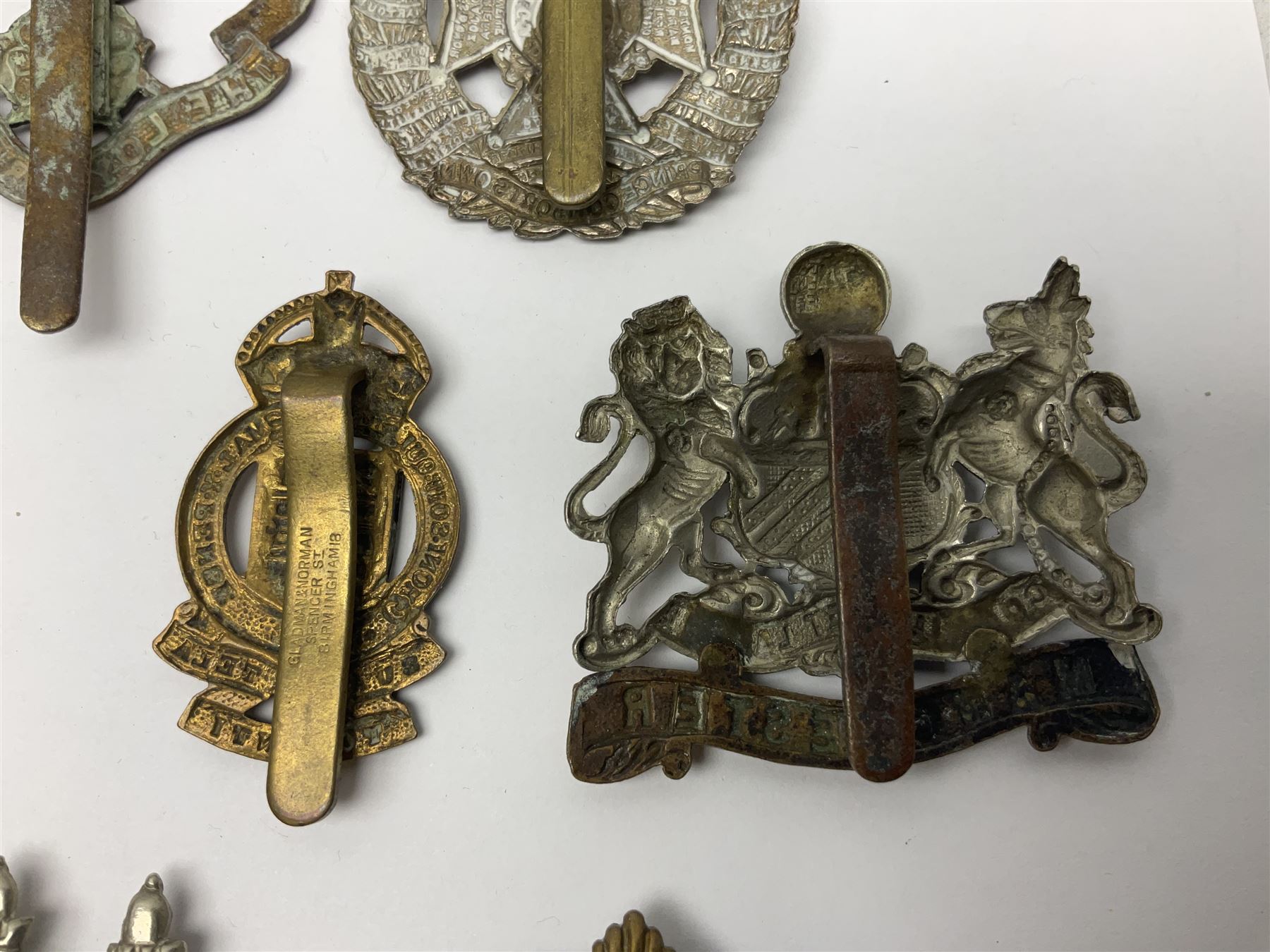 Twenty cap badges including Hertfordshire, Royal Sussex, Cambridgeshire, Hampshire, Notts and Derby, East Surrey, Herefordshire, South Lancashire, Devonshire, Bedfordshire, Durham Light Infantry etc (20)