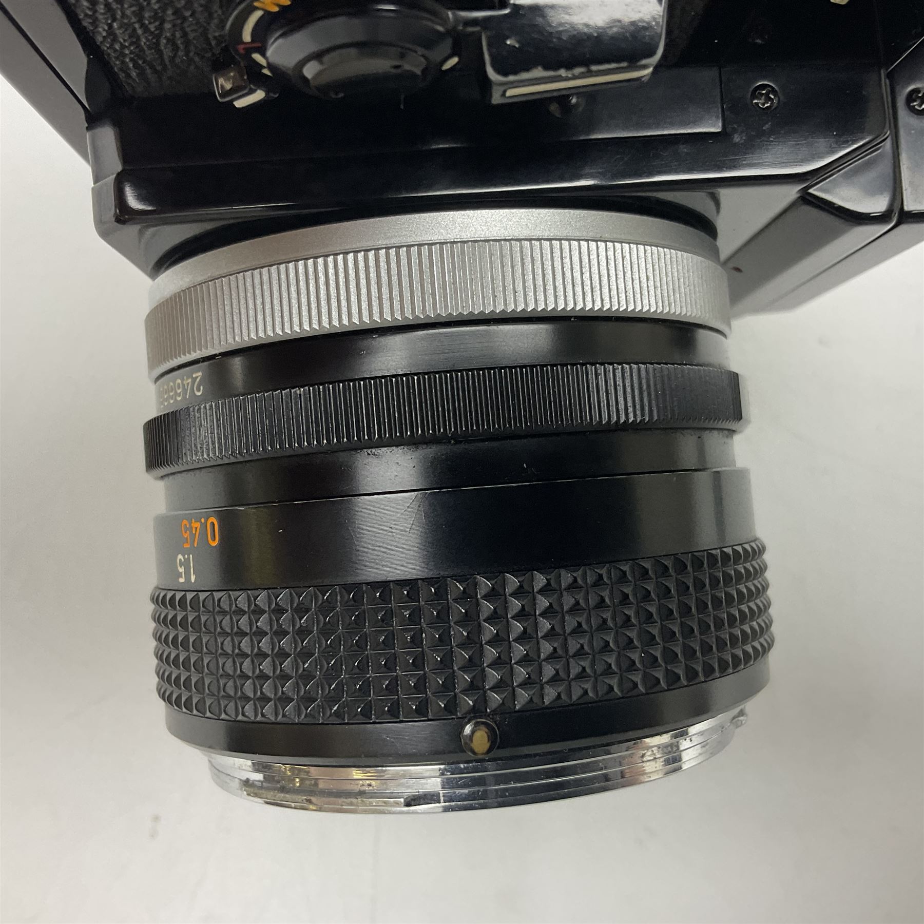 Canon F1n camera body, serial no. 572972, with 'Canon FD 50mm 1:1.4' lens, serial no. 246665, with leather case 