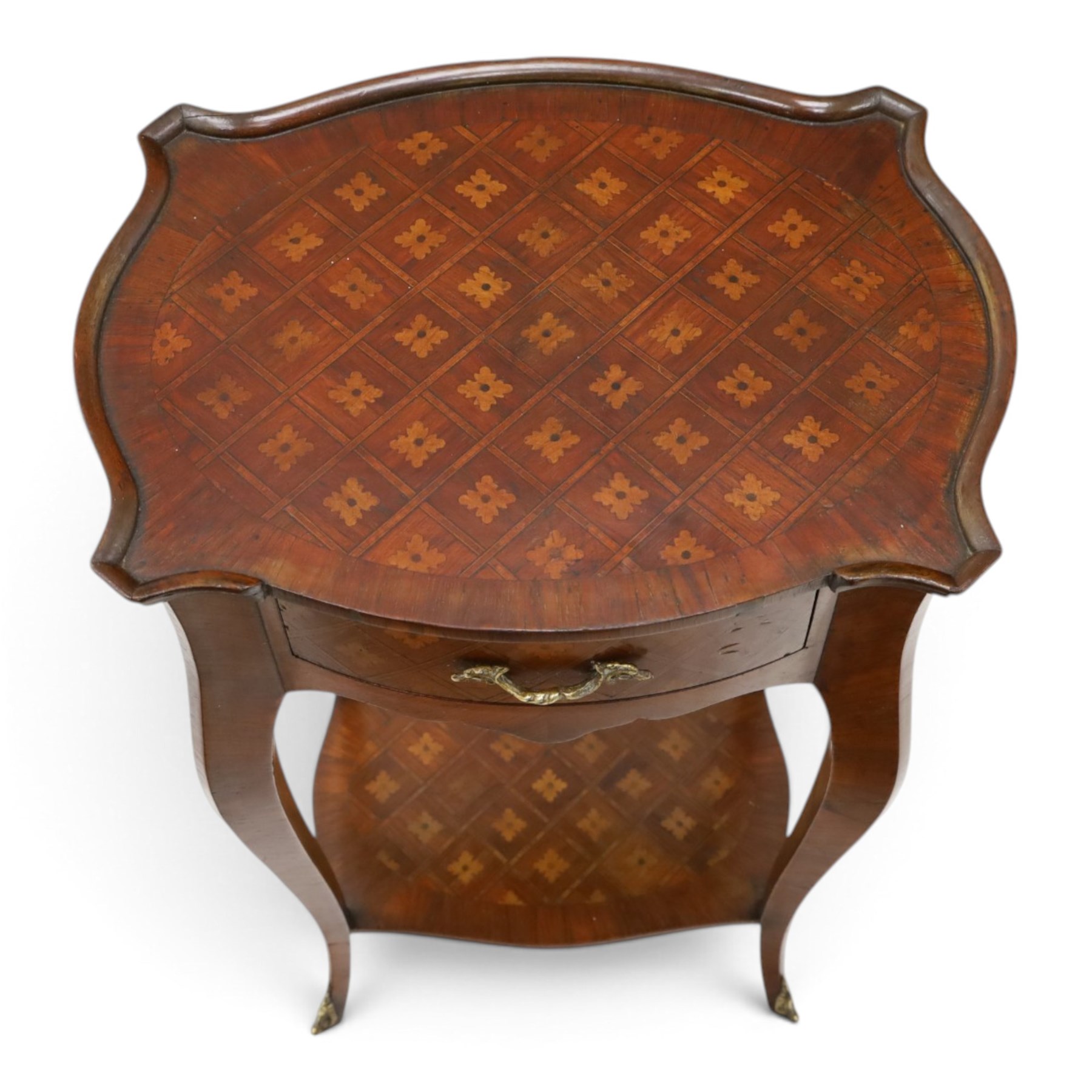 Small French inlaid marquetry and parquetry occasional table or bedside, the shaped top with raised moulded edge and chequered inlay top with crossbanding, fitted with single frieze drawer with gilt-metal handle, raised on cabriole supports united by undertier