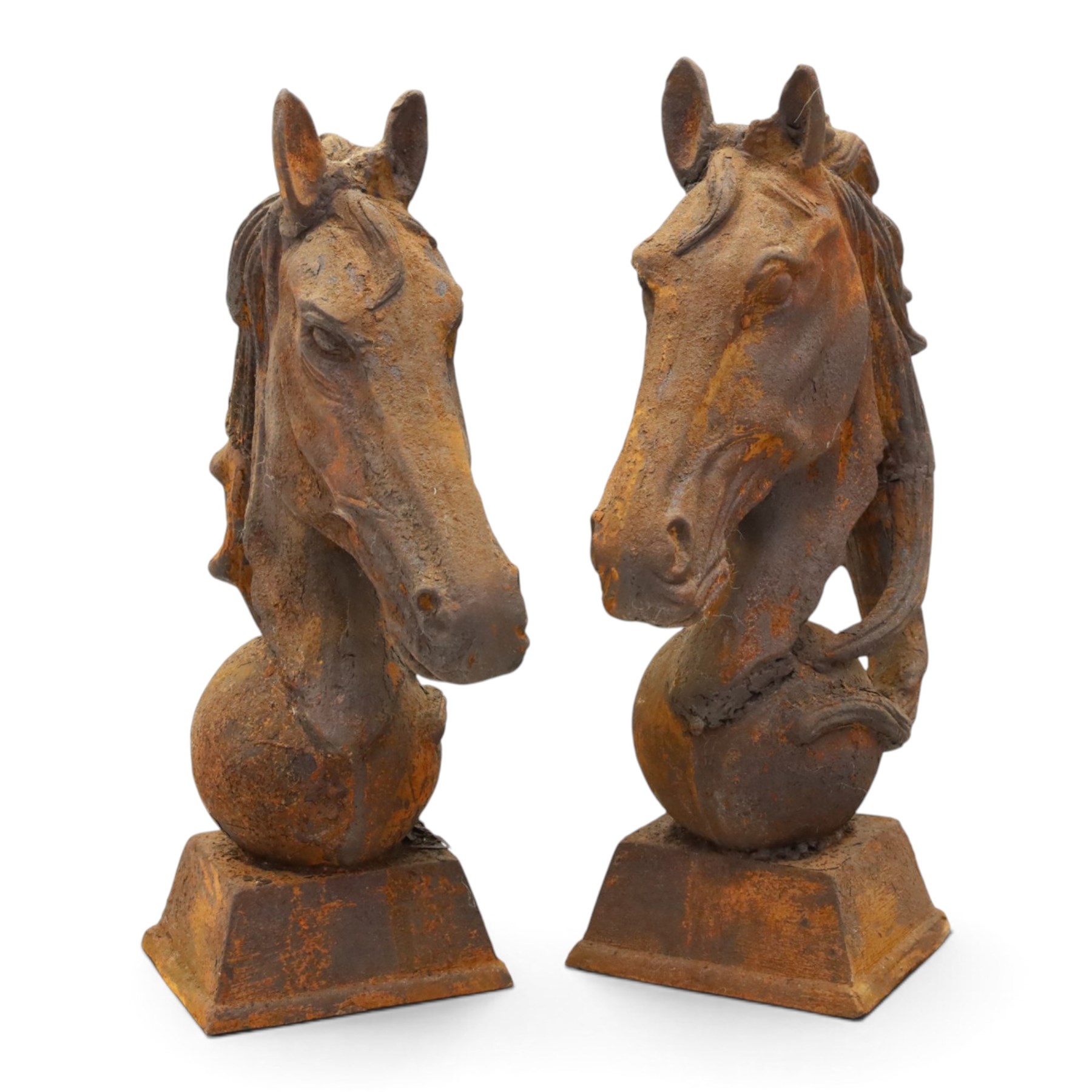 Pair of antique cast iron garden finials or statues of horse heads or busts, the heads with flowing and pierced mane, mounted on spherical finials over square tapering bases
