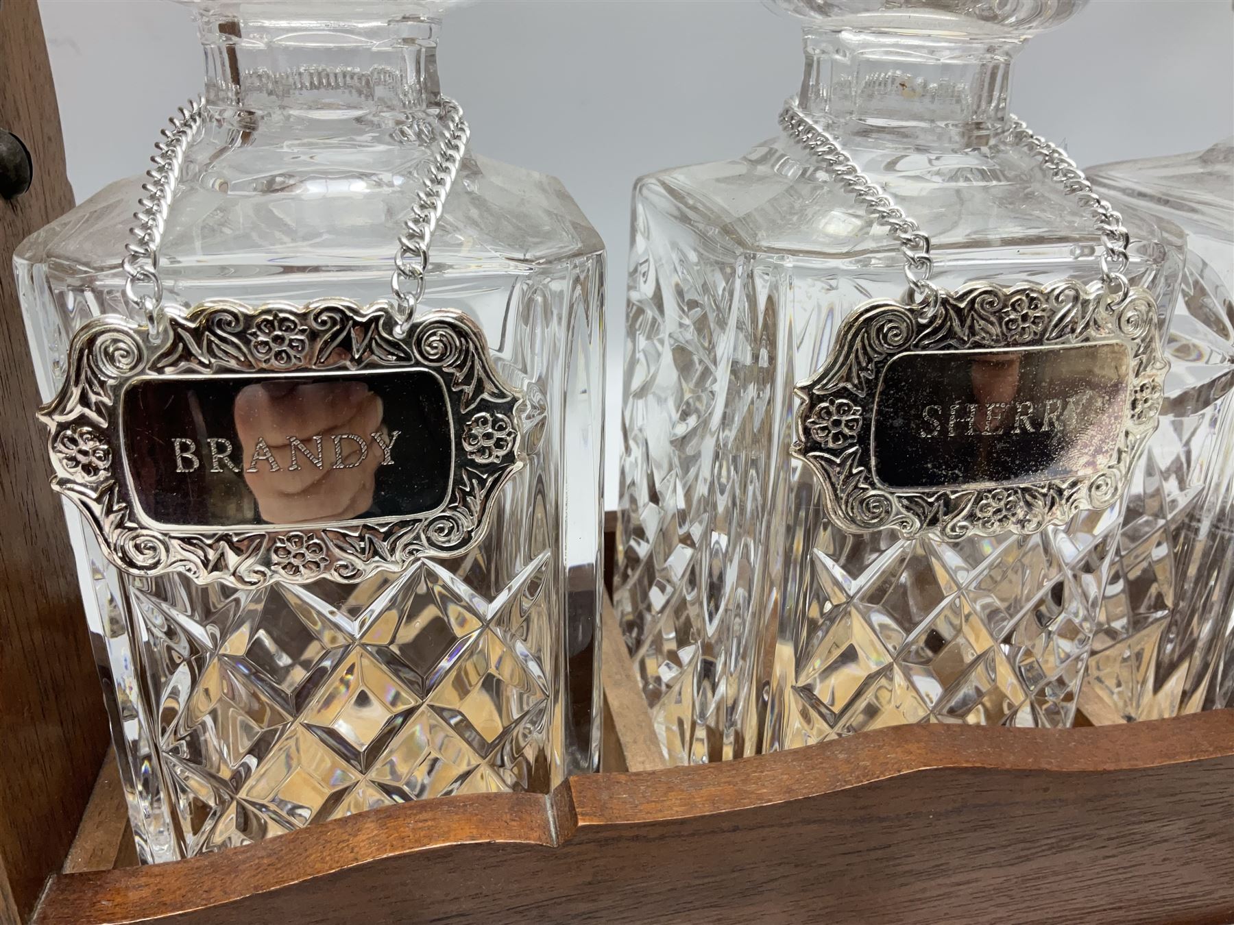 Edwardian silver plate mounted oak tantalus, containing three square sided cut glass decanters, complete with key, H33cm