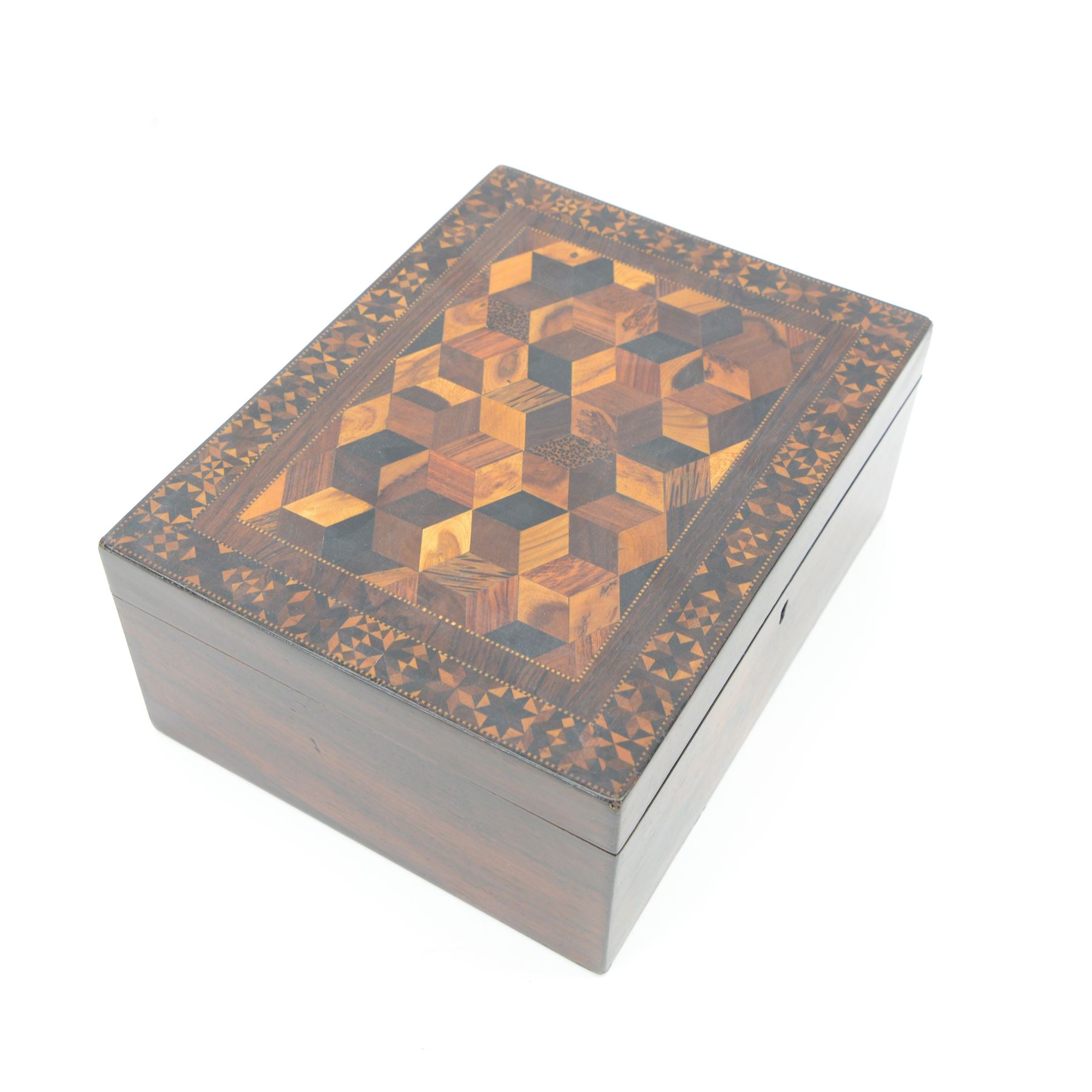 19th century Tunbridge ware marquetry box, the hinged cover decorated with tumbling blocks in specimen timbers and hardwood, within a star border, H10cm W23.5cm D18cm