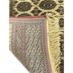 Bokhara beige and pink ground rug, repeating border, geometric patterned field (167cm x 124cm) and a similar rug