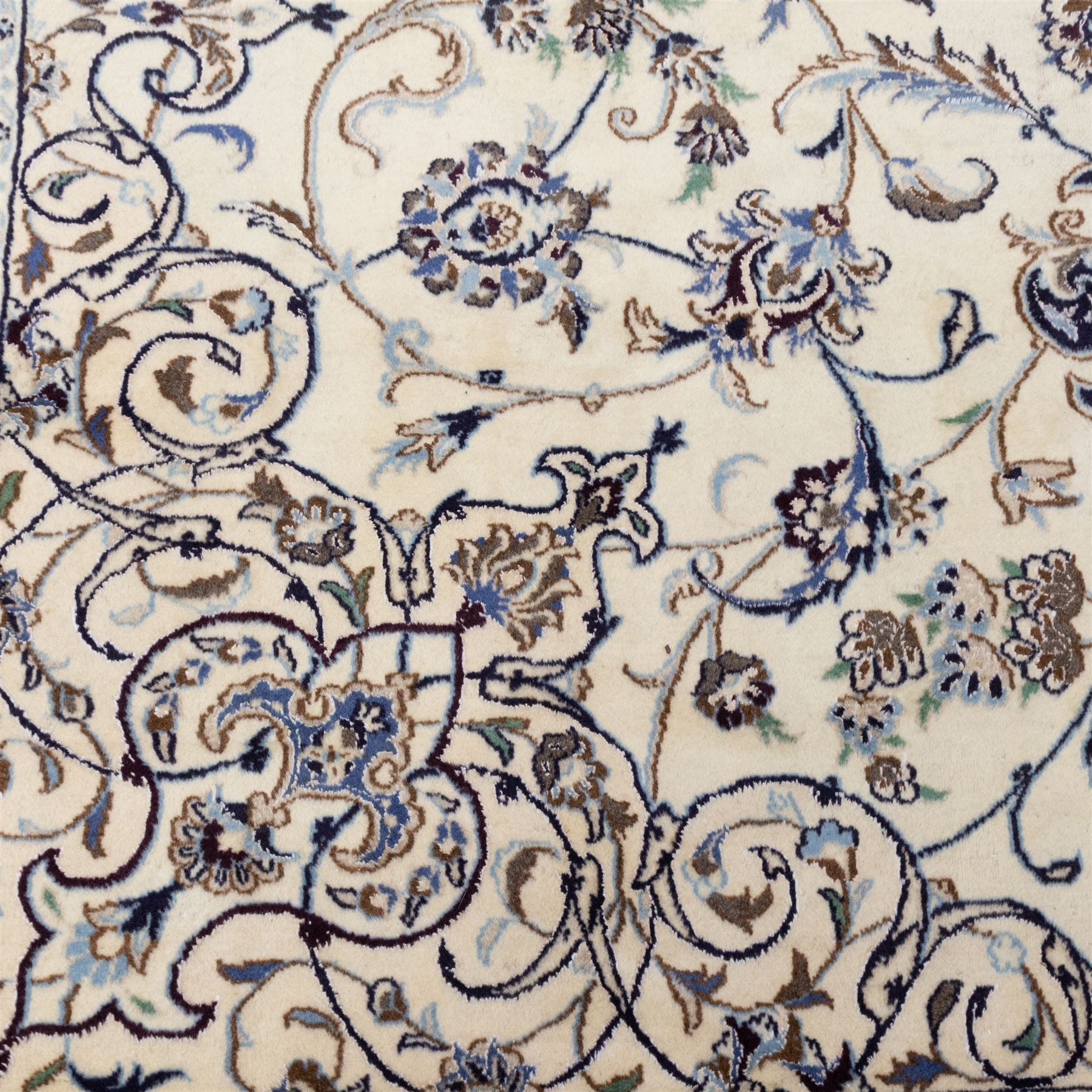 Central Persian Nain hand-knotted carpet, wool with silk highlights, ivory field with central radiating medallion surround by an intricate arrangement of scrolling vines and floral motifs, within conforming spandrels and matching border, cotton fringe ends 