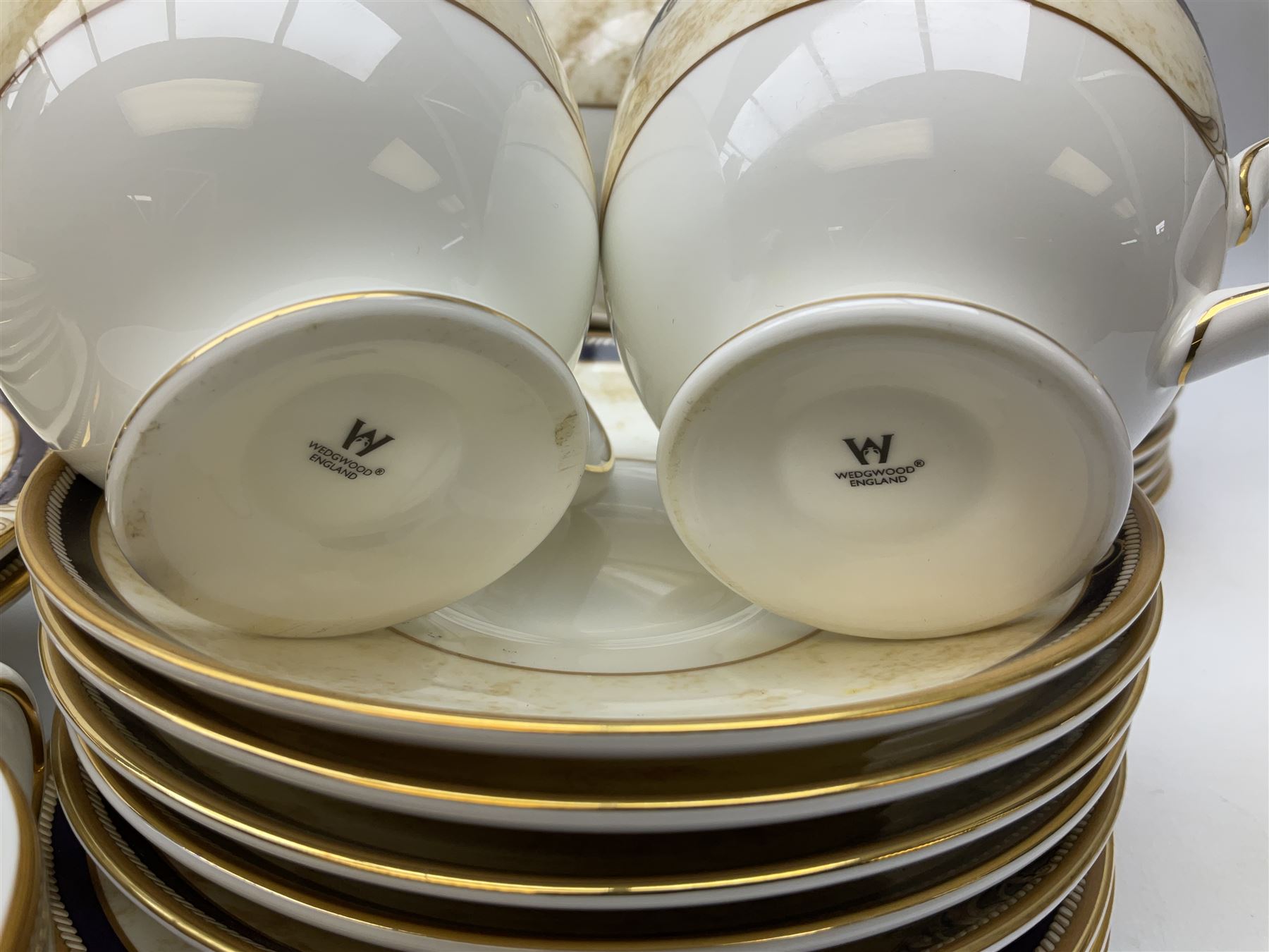 Wedgwood cornucopia pattern tea and dinner service, comprising teapot, ten cups and saucers, milk jug, open sucrier, eight dessert plates, fourteen dinner plates, eight side plates, six bowls, two open serving dishes and one covered twin handled dish (53)