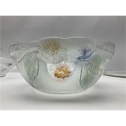 Two French pressed glass bowls of shallow circular form, relief moulded with flowers and foliage, together with a matching charger, largest bowl D34cm  