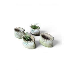 Four cast stone garden planters in the form of ribbon tied planting sacks