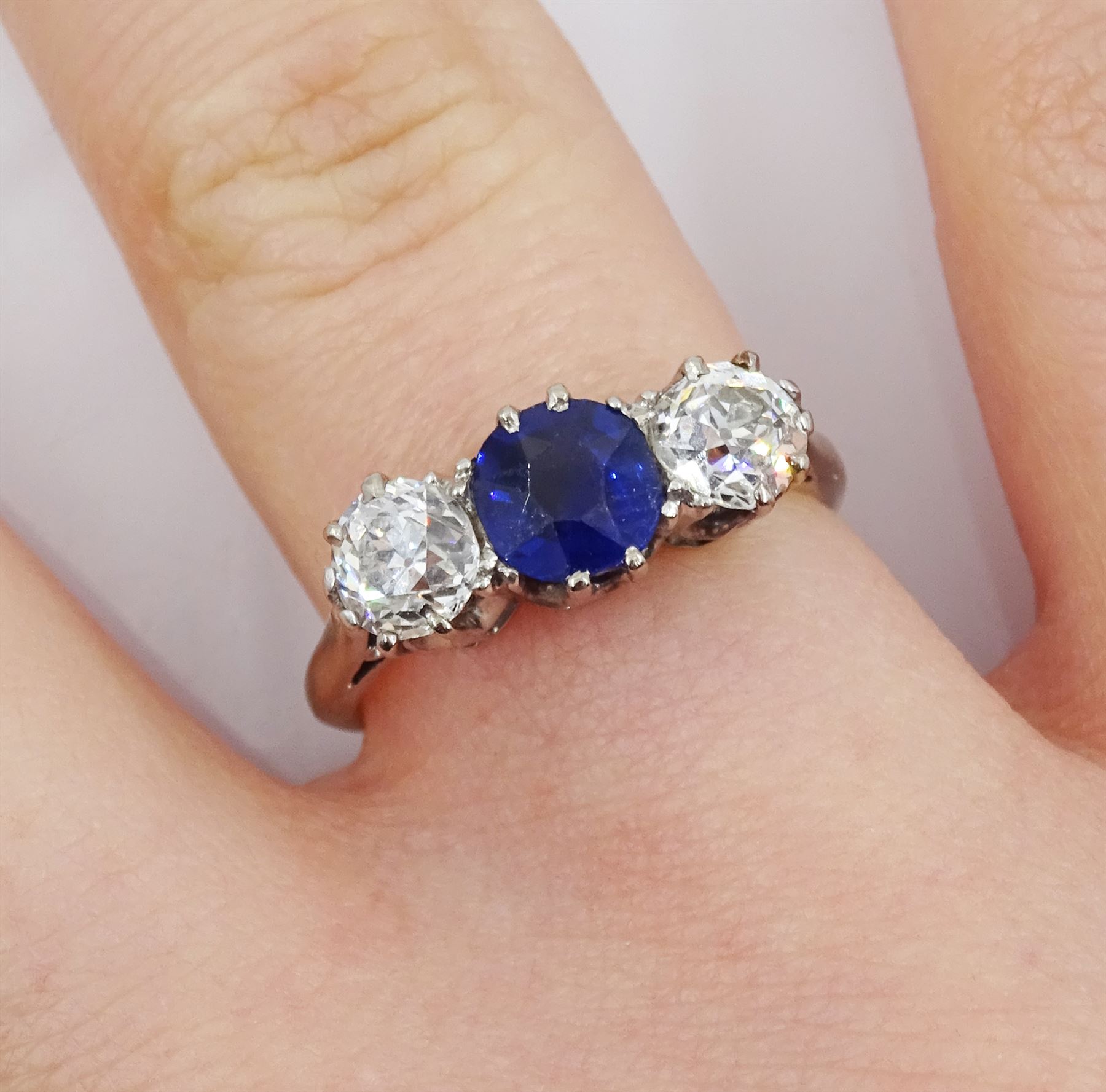 Early 20th century gold three stone old cut diamond and round sapphire ring, sapphire approx 0.60 carat, total diamond weight approx 1.00 carat