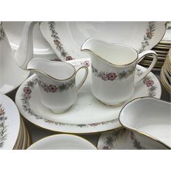 Royal Albert Paragon tea and dinner service for twelve decorated in the Belinda pattern, comprising fourteen saucers, twelve teacups, thirteen side plates, teapot, sauce boat and stand, salt and pepper shakers, two jugs, sucrier, twelve dinner plates, twelve smaller plates, two lidded tureens, twelve bowls, twelve smaller bowls, cake plate, oval plate and oval dish (100)
