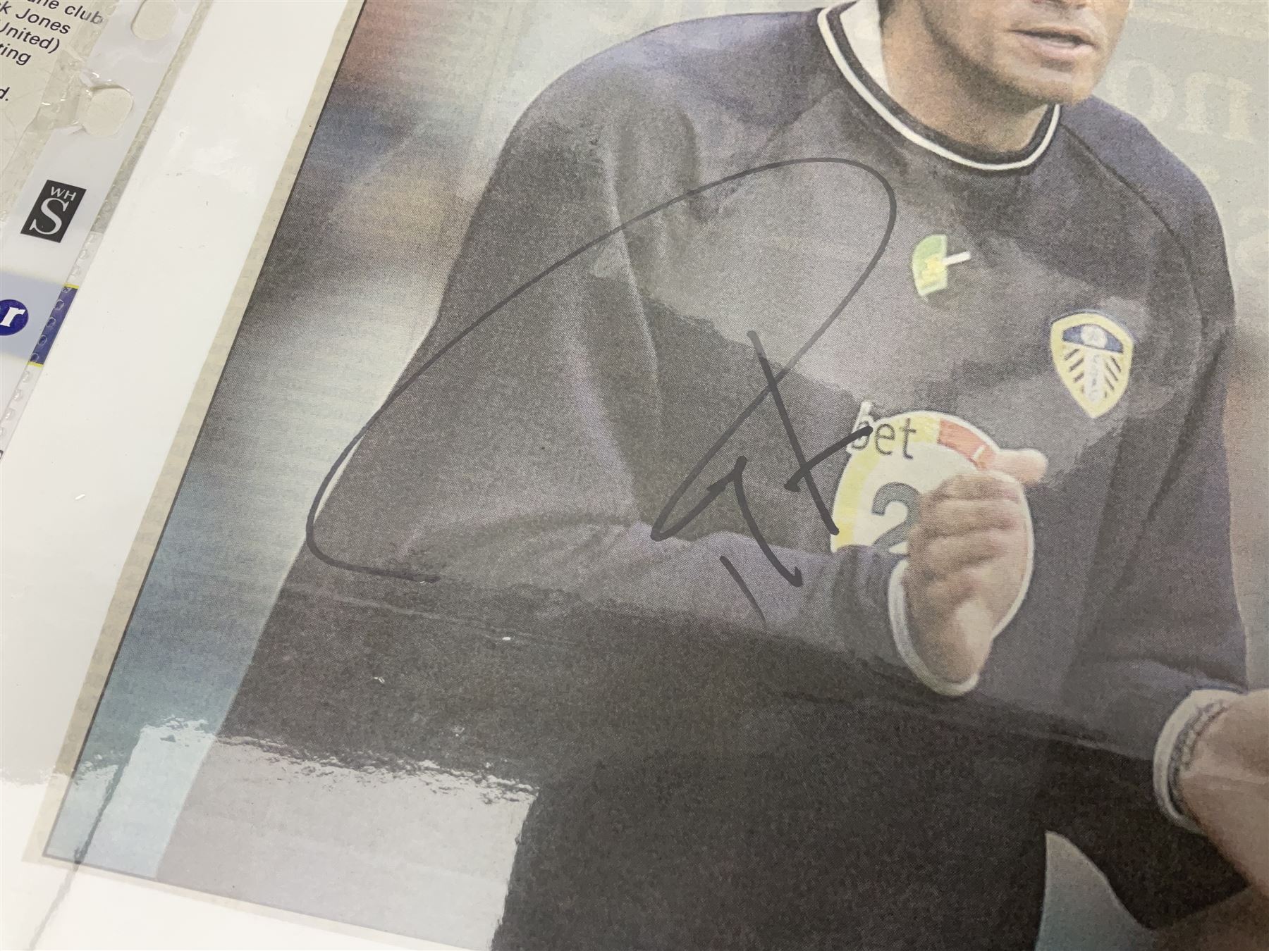 Collection of approximately 200 Leeds United related autographs, predominantly signed newspaper cuttings, contained within ring binder, together with a number of loose examples