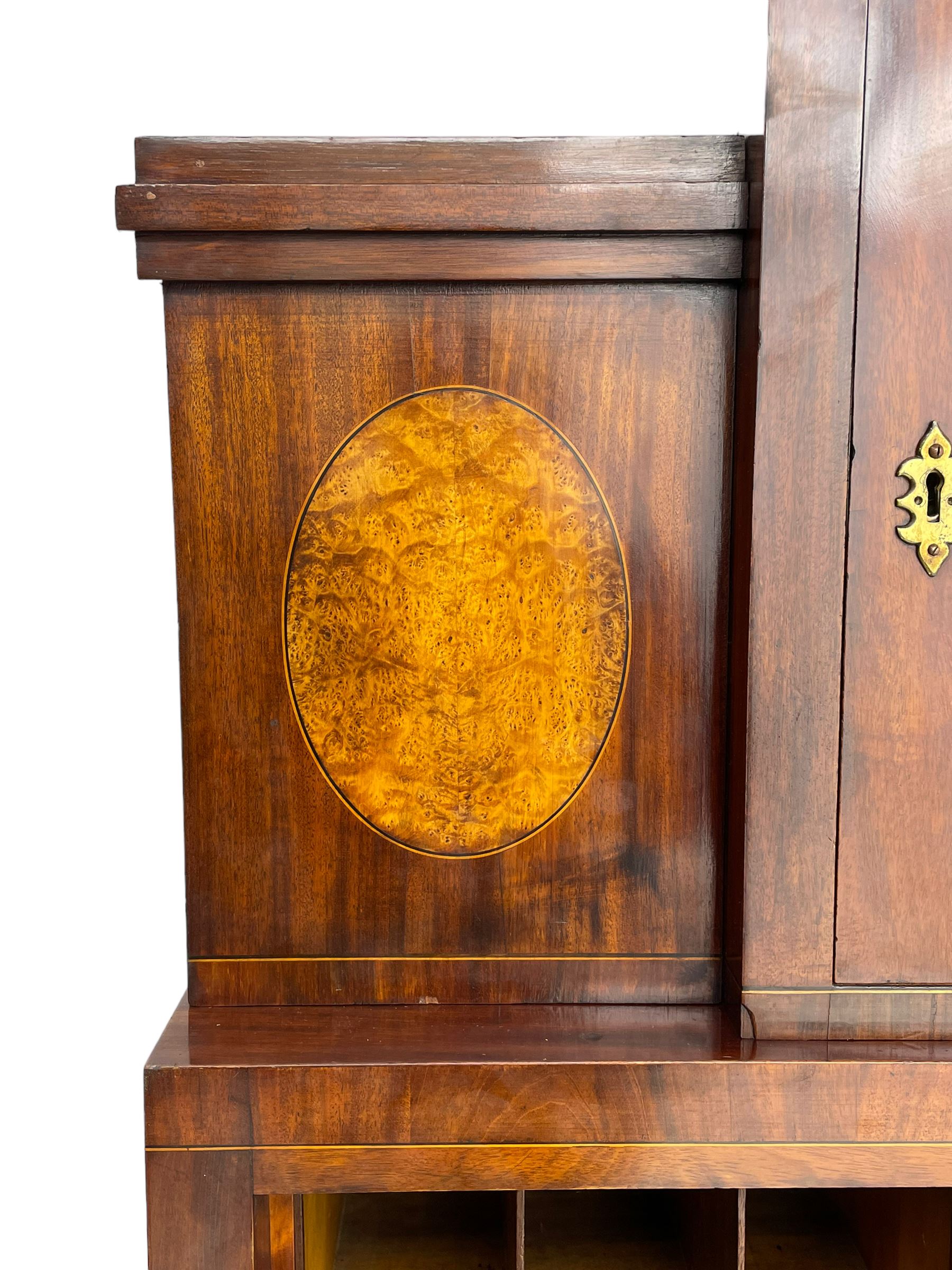 Early to mid-19th century figured mahogany Continental secrétaire à abattant, stepped top fitted with single cupboard, inlaid with oval figured amboyna panels, the fall front inlaid with shell motif enclosing a satinwood interior fitted with cupboard, drawers, and pigeon holes, three long drawers below, on square tapering feet