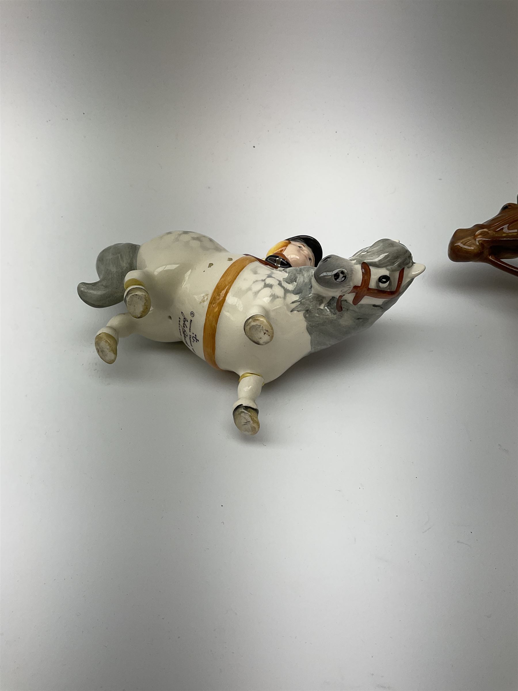 A Beswick equestrian figure modelled as a huntsman on bay horse, with printed mark beneath, together with a Beswick Norman Thelwell figure of a pony and rider, with printed mark beneath  