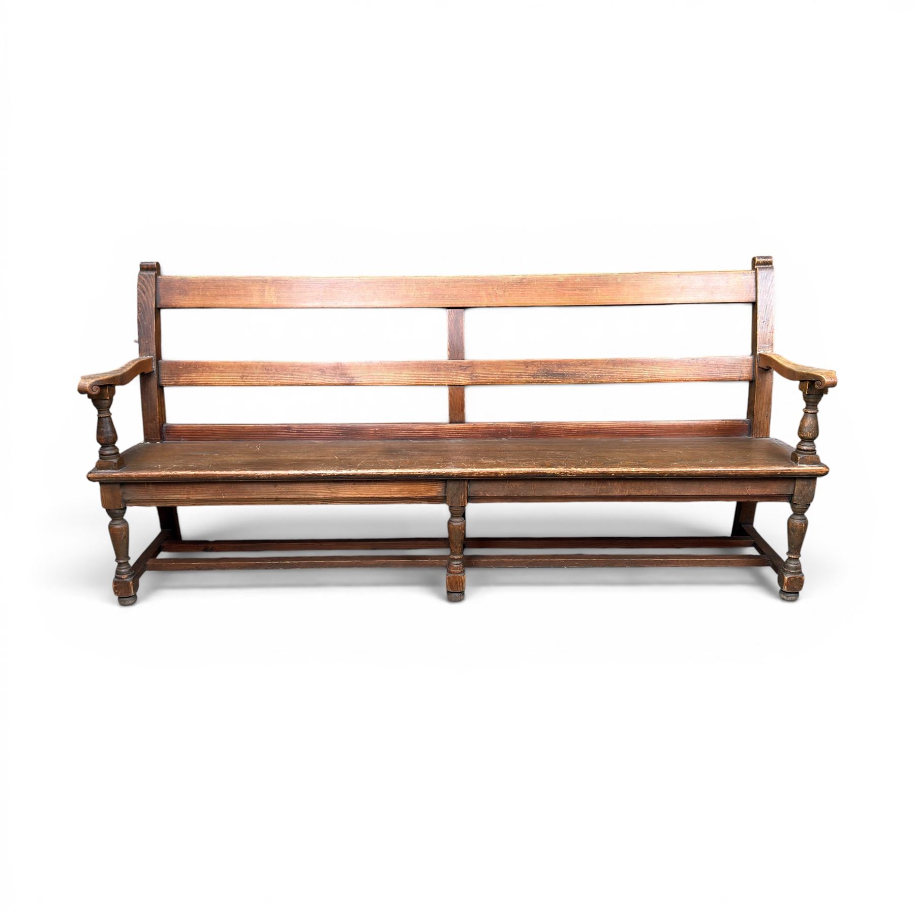 Early 20th century pine and oak bench seat, stained pine rail back frame with shaped oak arms