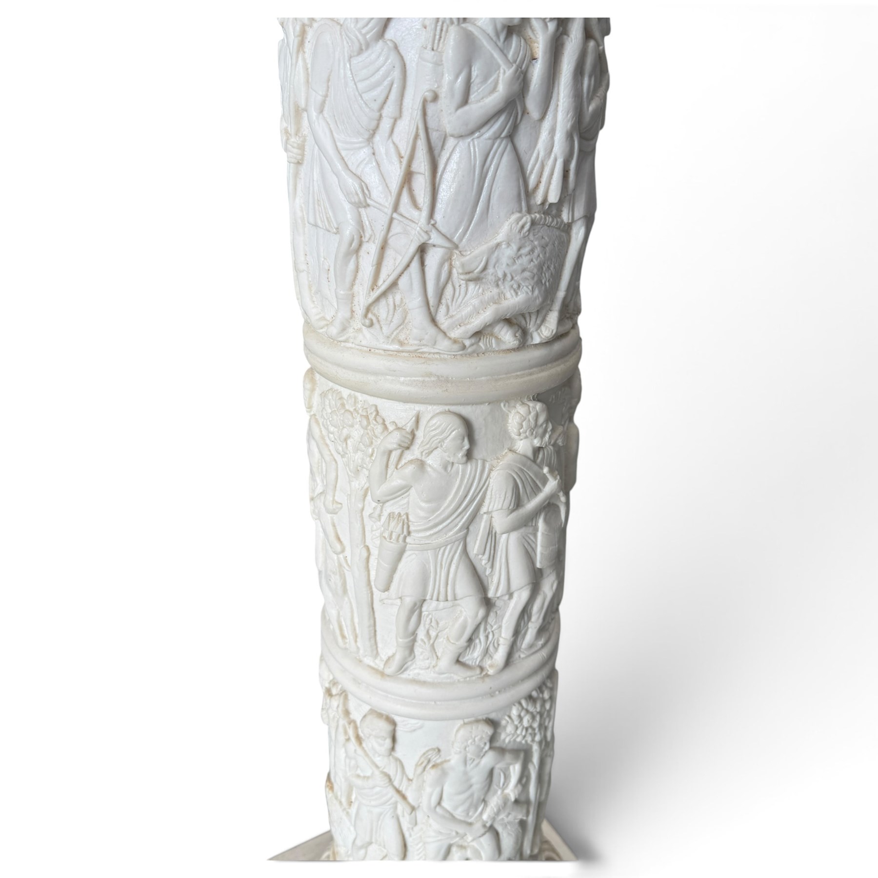 Neoclassical design composite column, square top over composite Ionic and Corinthian capital, the pedestal decorated with hunting and religious procession scenes, waisted and foliate socle on square base
