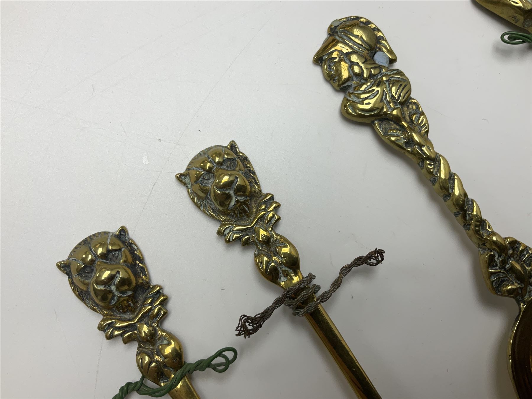 George III oak spoon rack and candle box, the rectangular backplate with shaped  pediment and two six aperture spoon racks, above a candlebox with hinged cover, with various brass spoons and a pair of brass candle snuffers, H56.5cm, W35cm, D14cm 