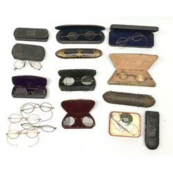 Twelve pairs of Georgian and later spectacles, one pair marked TA&B, with eleven cases, including a Victorian papier mache example.