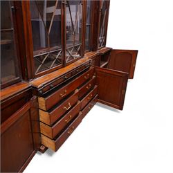 Large Georgian mahogany library bookcase, projecting moulded cornice with row of globular mounts, adjustable shelving enclosed by six astragal glazed doors, fitted with two slides and six panelled cupboard doors, two banks of five drawers, on moulded plinth base; together with two pairs of associated astragal glazed doors in mahogany, from the same property (W55.5cm x H168cm & W48cm x 168cm)