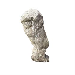 Four weathered cast stone lions in seated poses