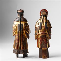 Pair of Chinese carved wooden lacquered figures, in ceremonial dress, possibly wedding attire, highlighted throughout in gilt, H22cm