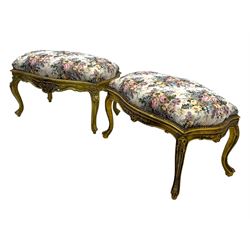 Pair of Louis XV-design giltwood stools, each upholstered in floral tapestry fabric, the carved frame adorned with scrolling foliage and shell motifs, raised on cabriole supports