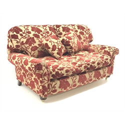  Two seat sofa, scrolled arms, upholstered in a patterned red and gold fabric, turned supports on castors (W180cm) and an armchair upholstered in red and stripped fabric, turned supports on castors (W102cm)  