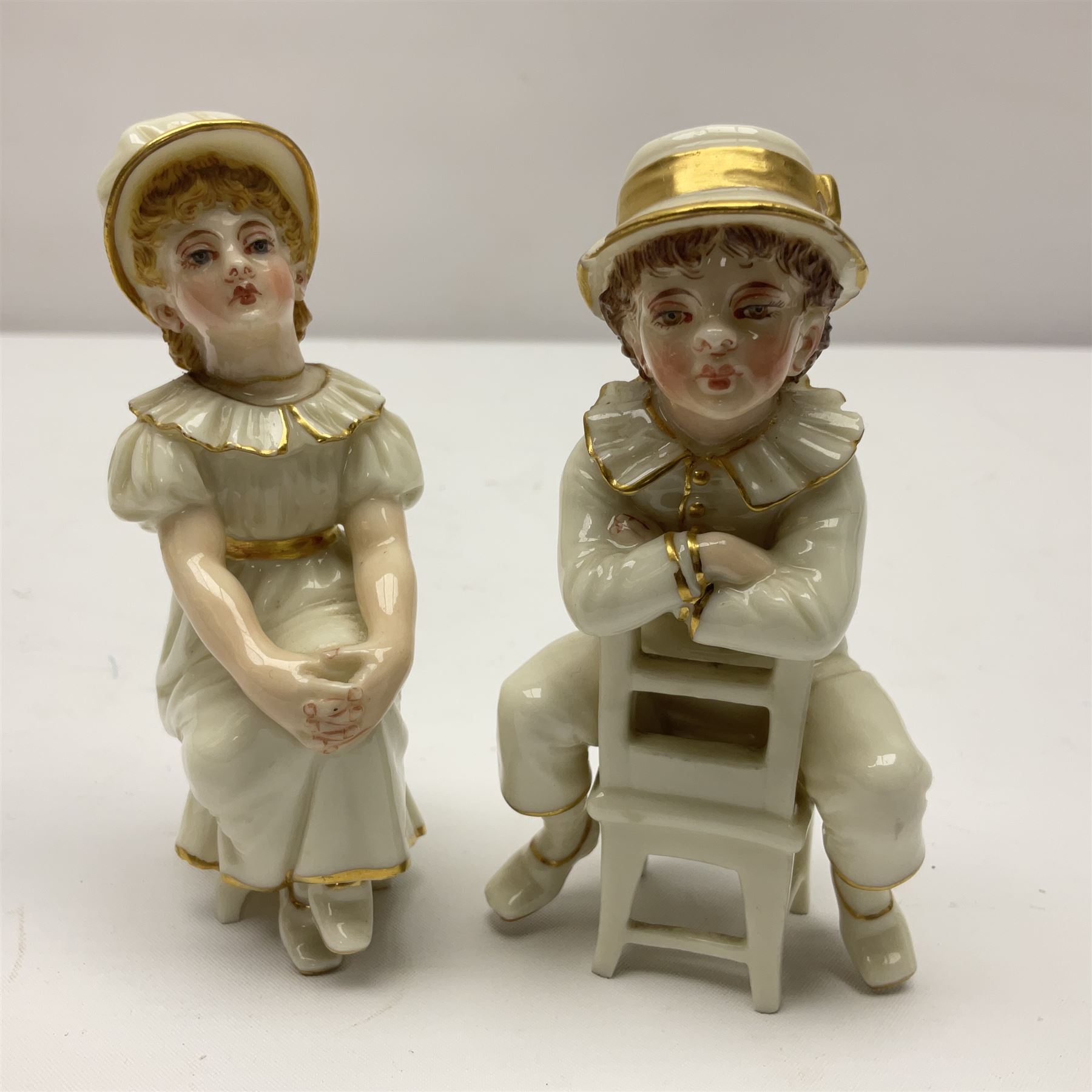 Royal Worcester tusk jug, blush ivory ground, with floral design, stamped 1116 to the base,, together with pair figures of a young boy and girl in the style on Kate Greenaway 